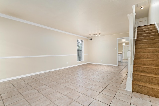 unfurnished room featuring rail lighting, ceiling fan, light tile patterned floors, and crown molding