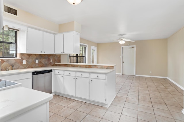 kitchen with kitchen peninsula, backsplash, stainless steel dishwasher, white cabinets, and light tile patterned flooring