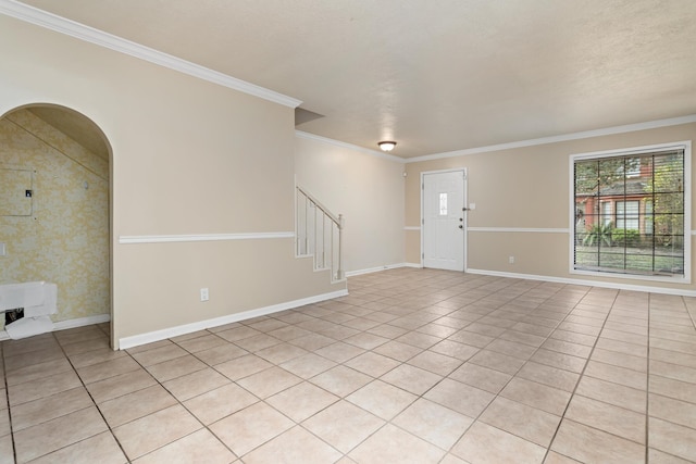 tiled spare room featuring a textured ceiling, crown molding, and electric panel