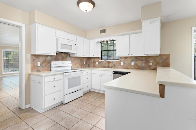 kitchen featuring light tile patterned floors, white cabinets, and white appliances