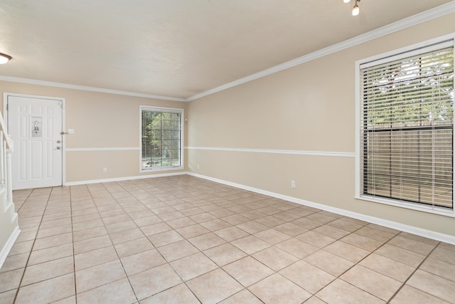 tiled spare room featuring ornamental molding