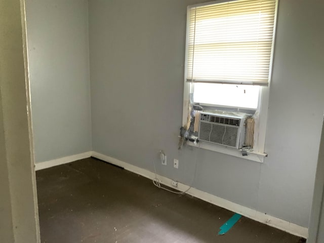 empty room with cooling unit and baseboards