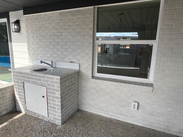 exterior space with brick wall and sink