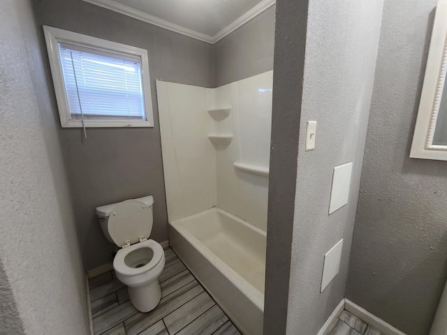 bathroom with toilet, a shower, and crown molding