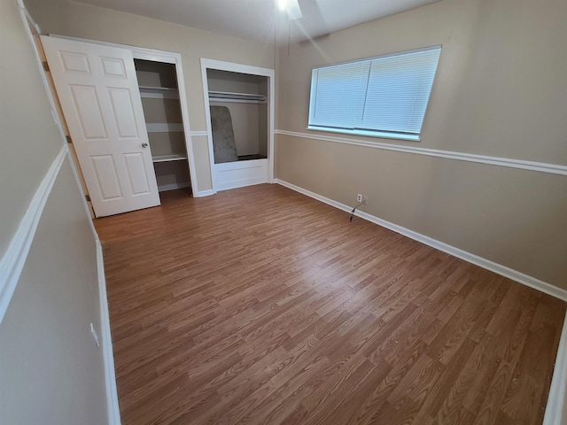 unfurnished bedroom featuring hardwood / wood-style floors and ceiling fan