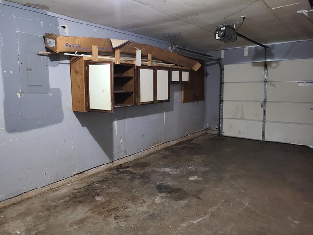 garage featuring electric panel and a garage door opener