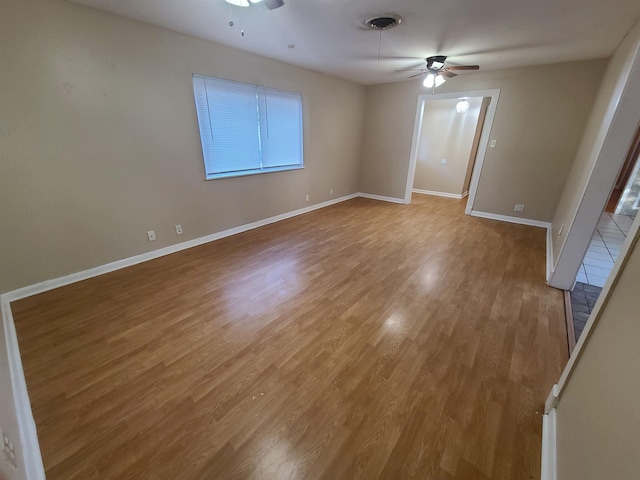 unfurnished room with ceiling fan and light wood-type flooring