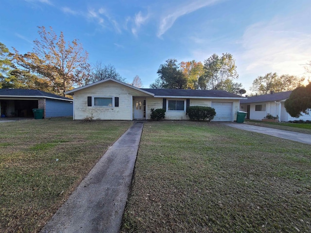 ranch-style home with a garage and a front yard