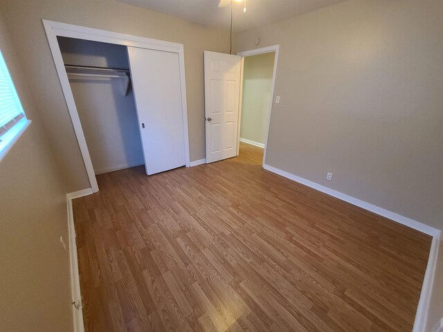 unfurnished bedroom with a closet and light hardwood / wood-style floors