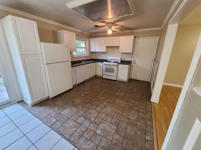 kitchen with tasteful backsplash, white appliances, ceiling fan, sink, and white cabinets