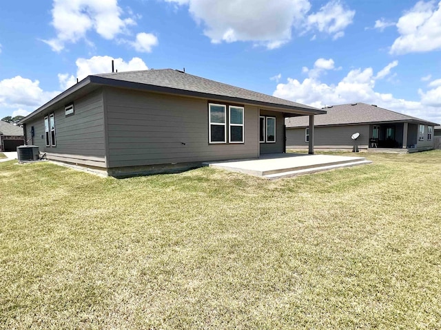 back of house featuring central AC, a yard, and a patio area