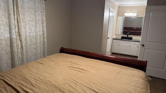 bedroom with crown molding and a textured ceiling