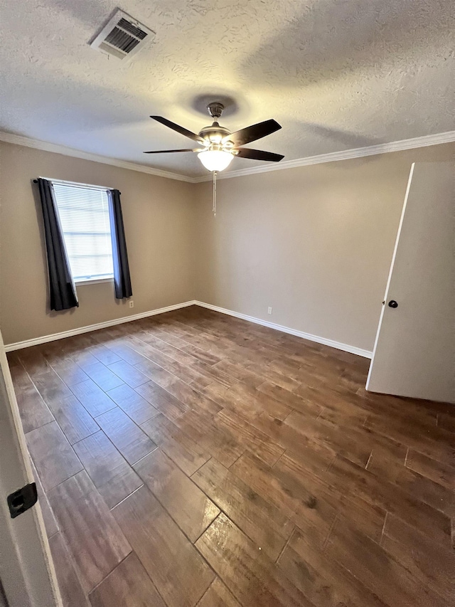 spare room featuring ornamental molding, a textured ceiling, and dark wood-type flooring