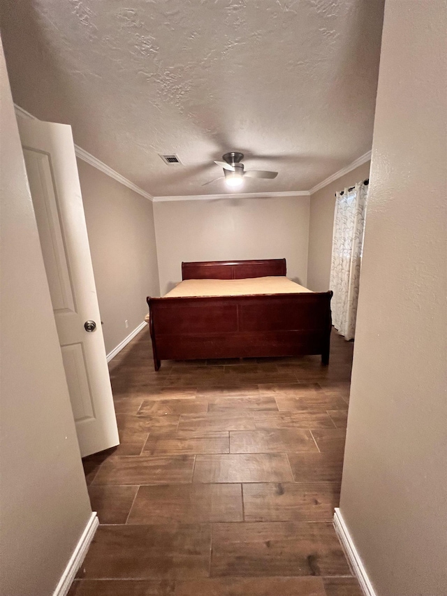 unfurnished bedroom with crown molding, ceiling fan, and a textured ceiling