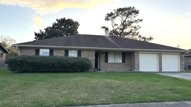 single story home with a lawn and a garage