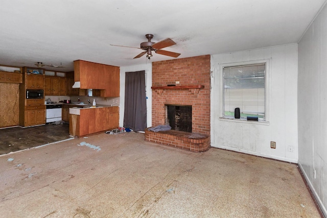 unfurnished living room with a fireplace and ceiling fan