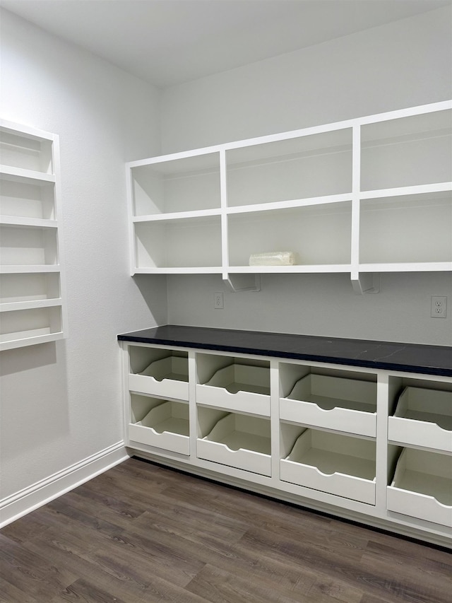 interior space featuring baseboards and wood finished floors