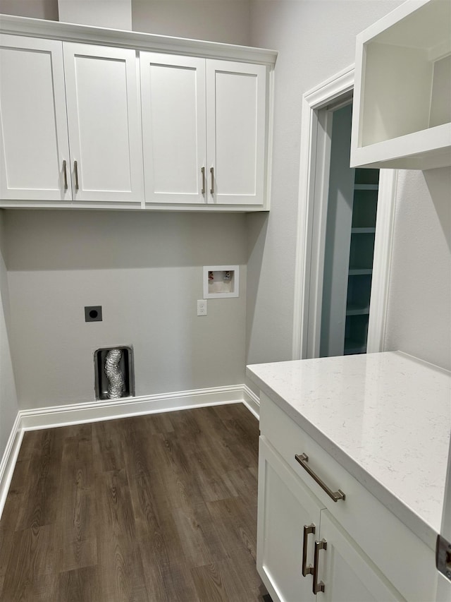 laundry area with dark wood finished floors, cabinet space, electric dryer hookup, and washer hookup