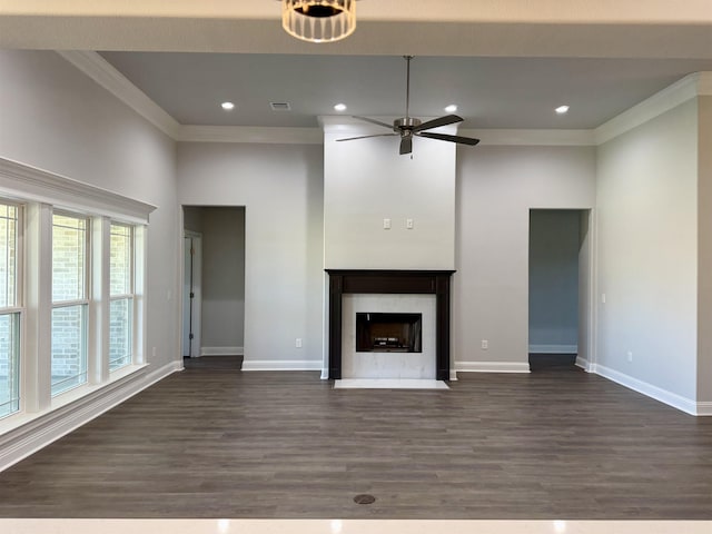 unfurnished living room featuring dark wood-type flooring, a ceiling fan, and ornamental molding