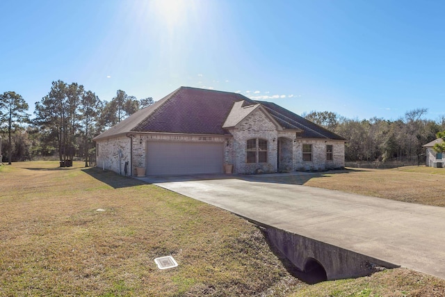 view of front facade with a front yard and a garage