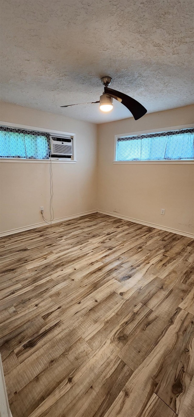 unfurnished room featuring a textured ceiling and wood finished floors