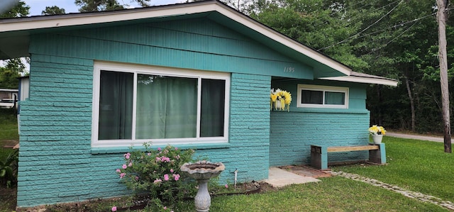 view of home's exterior with a yard
