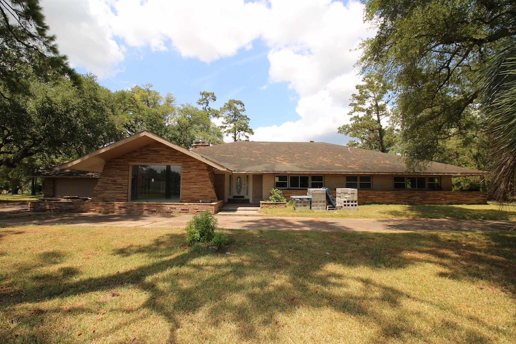 rear view of house with a patio area and a lawn