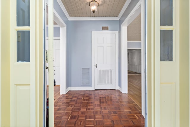 hallway featuring visible vents, baseboards, and ornamental molding