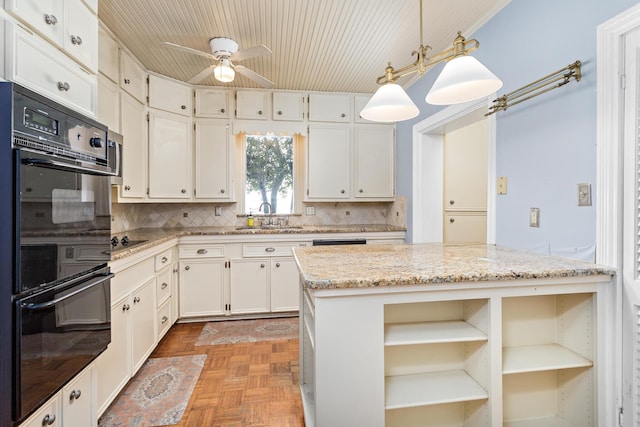 kitchen with backsplash, ceiling fan, decorative light fixtures, light stone counters, and black appliances