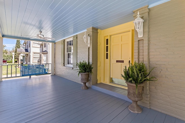 deck with a porch and ceiling fan