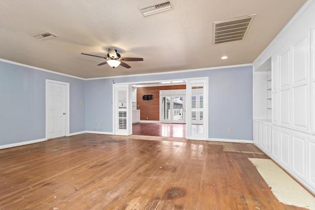 unfurnished living room with visible vents, wood-type flooring, and ornamental molding