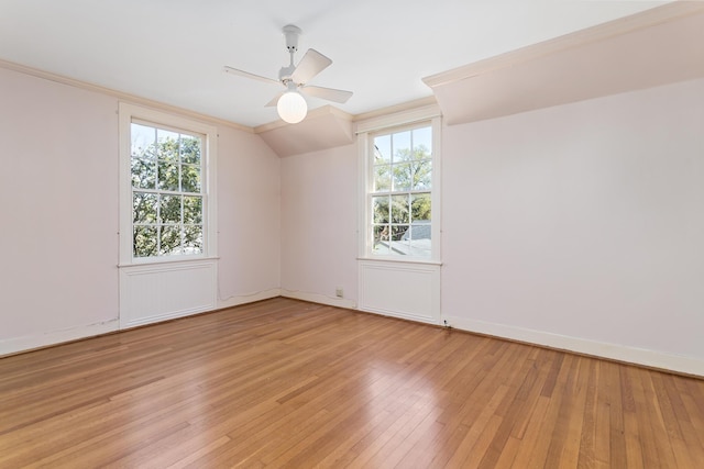 unfurnished room featuring ceiling fan, baseboards, light wood-type flooring, and lofted ceiling