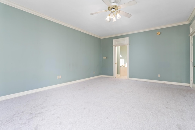 empty room featuring ceiling fan, baseboards, carpet, and ornamental molding