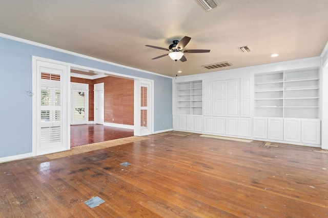 unfurnished room featuring visible vents, wood-type flooring, and ornamental molding