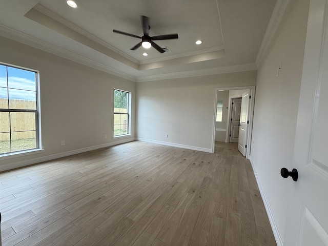 7735 Windcastle Dr, Beaumont, TX 77713 - empty room with a raised ceiling, light wood-style floors, a ceiling fan, crown molding, and recessed lighting
