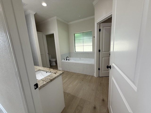 7735 Windcastle Dr, Beaumont, TX 77713 - bathroom with a garden tub, wood finished floors, crown molding, and vanity