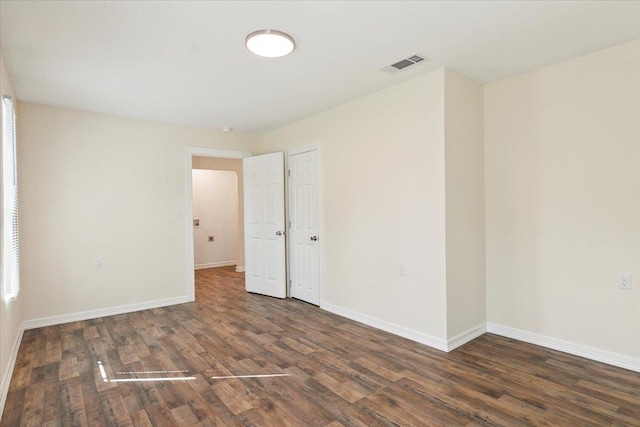 spare room featuring dark hardwood / wood-style flooring