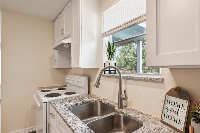 kitchen featuring white cabinetry, electric range, sink, and light stone countertops