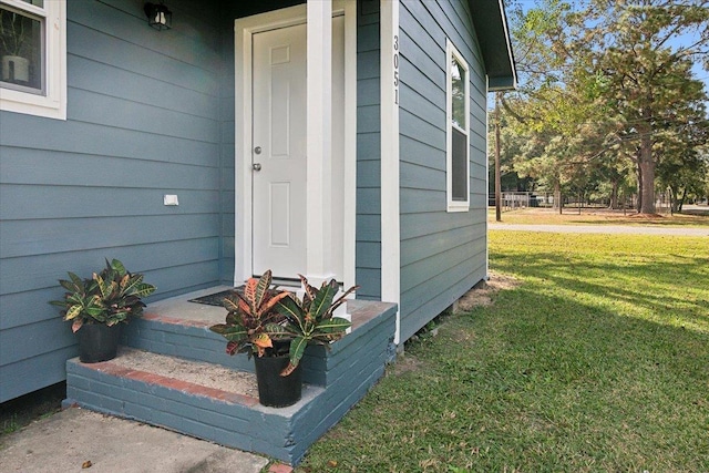 doorway to property featuring a yard