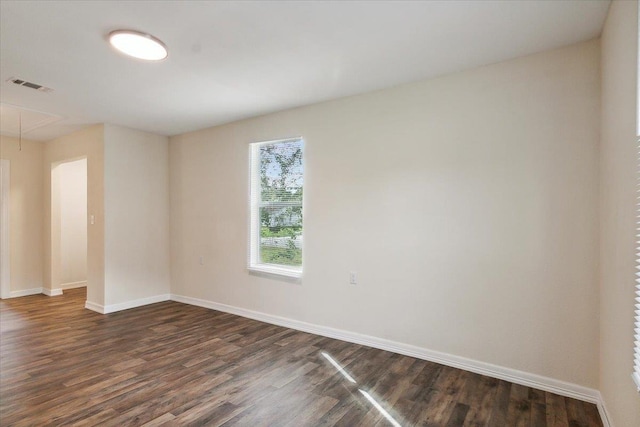 unfurnished room with dark wood-type flooring