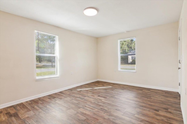 empty room with dark hardwood / wood-style flooring