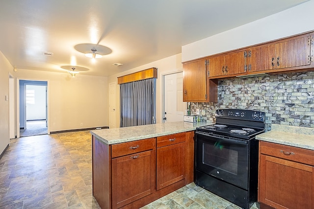 kitchen with light stone countertops, electric range, backsplash, and kitchen peninsula