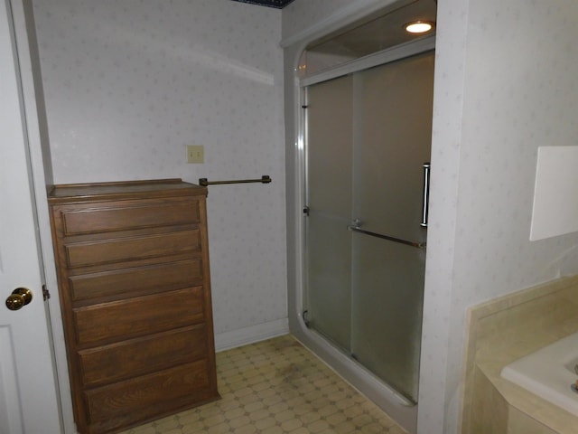 6340 Capitol St, Groves, TX 77619 - bathroom with wallpapered walls, a shower stall, tile patterned floors, and a bathtub