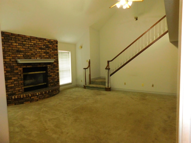 6340 Capitol St, Groves, TX 77619 - unfurnished living room with carpet floors, stairs, a ceiling fan, vaulted ceiling, and a brick fireplace