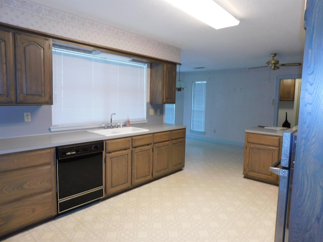 6340 Capitol St, Groves, TX 77619 - kitchen featuring dishwasher, light floors, wallpapered walls, light countertops, and a ceiling fan