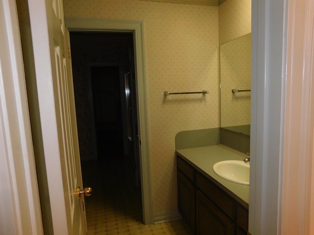 6340 Capitol St, Groves, TX 77619 - bathroom with vanity and wallpapered walls