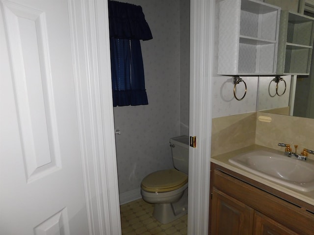 6340 Capitol St, Groves, TX 77619 - bathroom featuring wallpapered walls and vanity