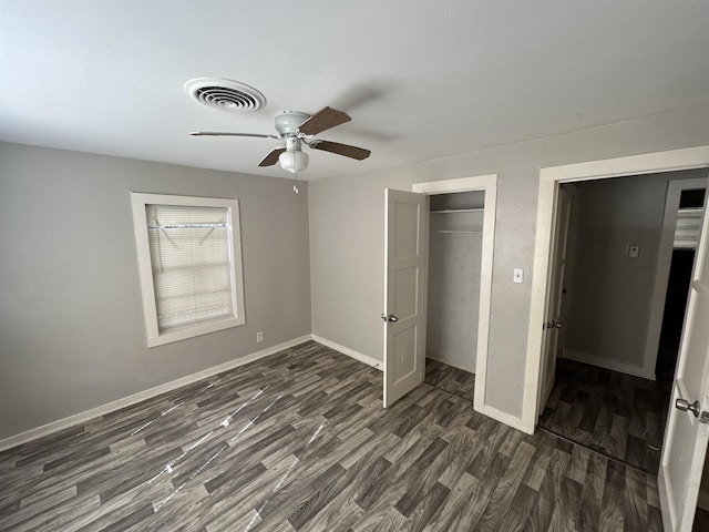 unfurnished bedroom featuring dark hardwood / wood-style floors and ceiling fan