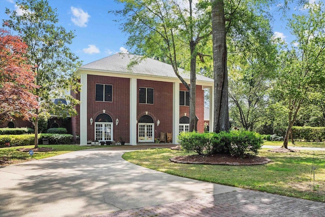 view of front of property with a front yard and french doors