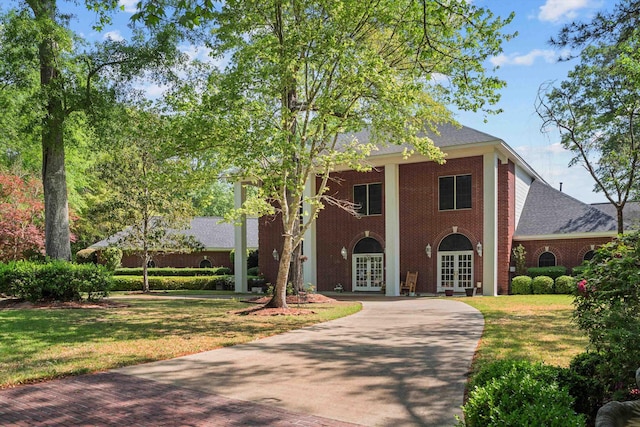 view of front of house with a front yard and french doors